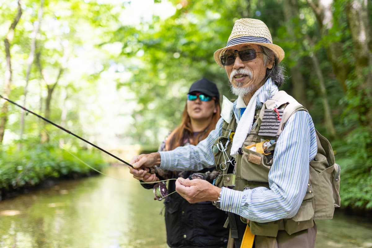 Fly fishing on a mountain stream surrounded by forest